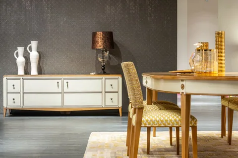 A classic dining room with upholstered chairs, timber table and decorative cabinetry